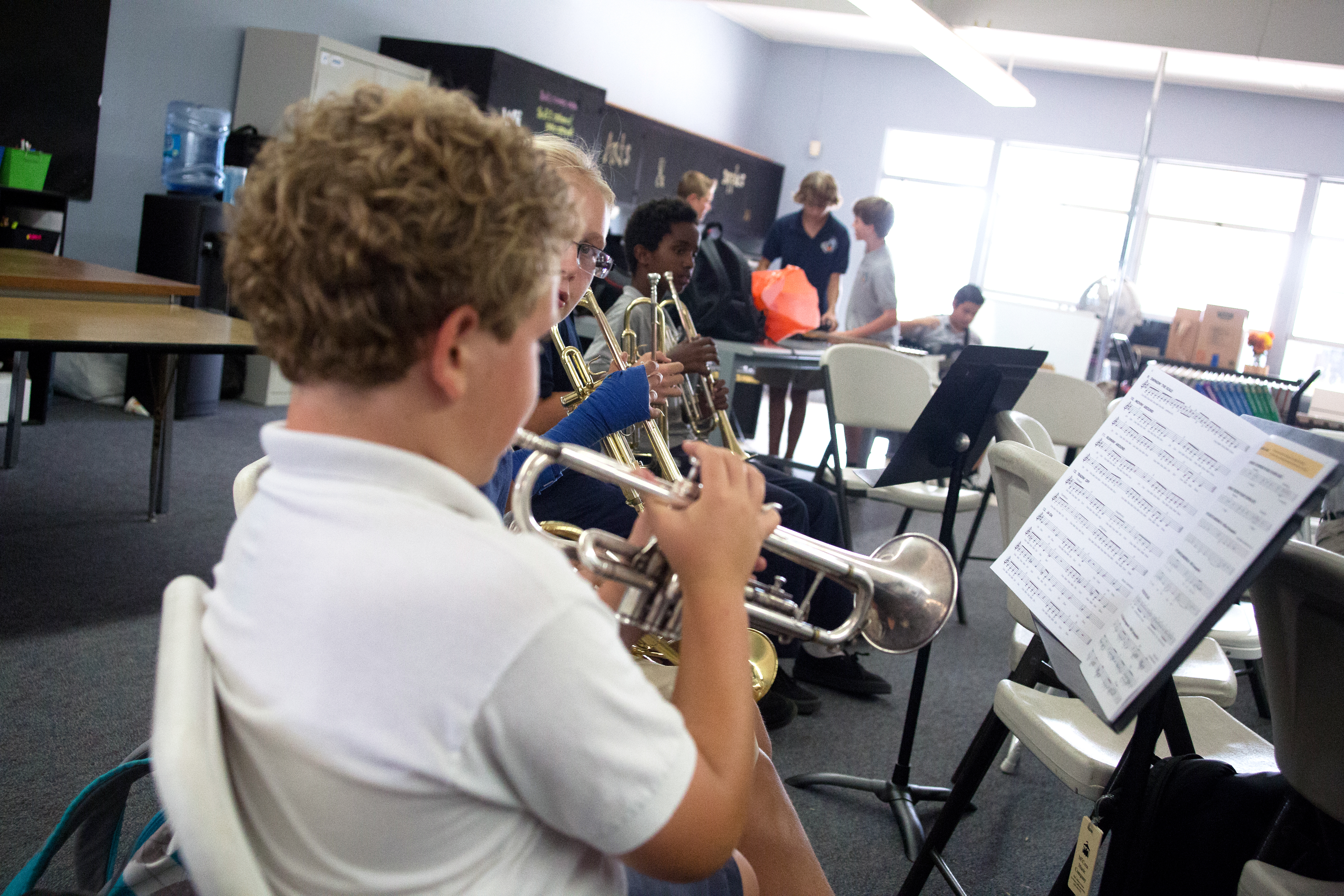 Male student playing trumpet in band class